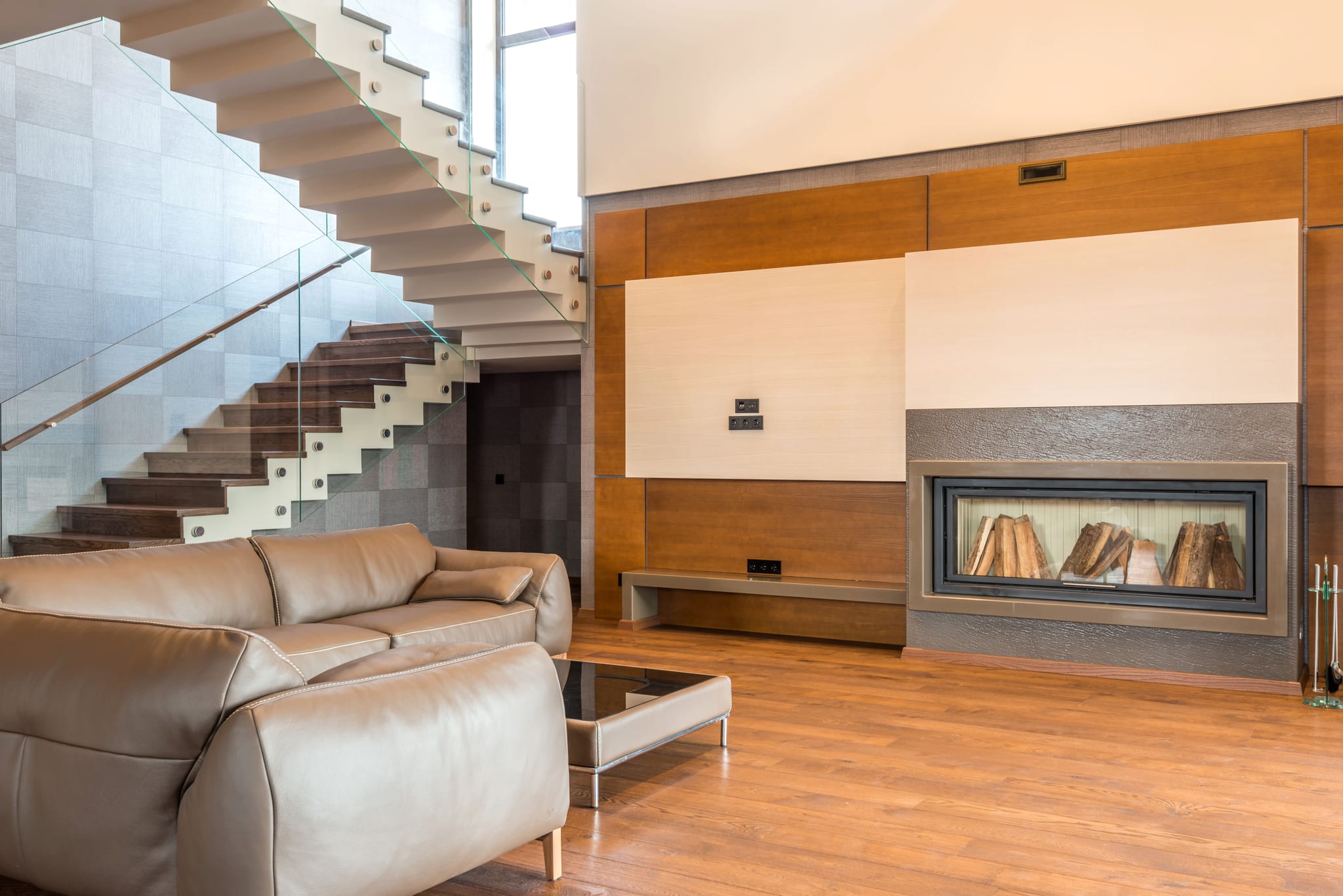 Warm, designed living room with fireplace, wood, and considered material choices