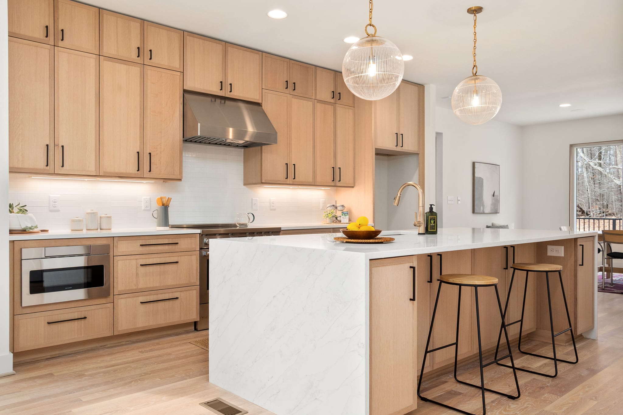 Renovated modern kitchen with white oak cabinetry and natural light